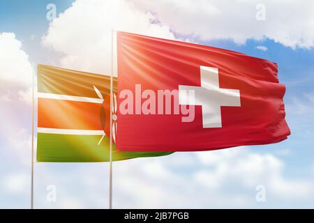 Cielo azzurro soleggiato e bandiere della svizzera e del kenya Foto Stock