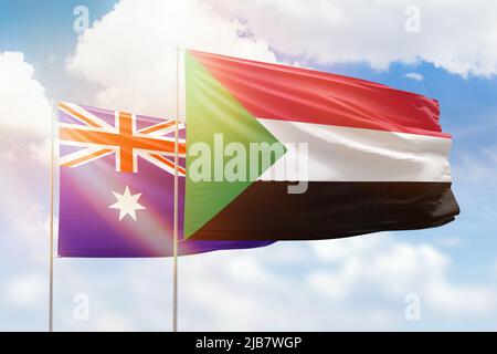 Cielo azzurro soleggiato e bandiere di sudan e australia Foto Stock