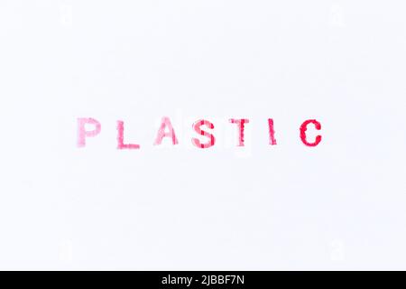 Timbro in gomma con inchiostro di colore rosso in plastica Word su sfondo di carta bianca Foto Stock