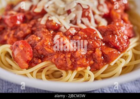 Sphaghetti alla filapina con fettine di hot dog e salsa di banana con parmigiano grattugiato Foto Stock