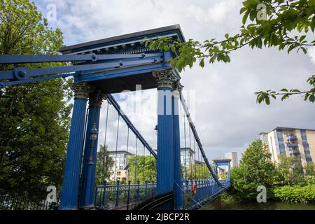 Il ponte sospeso di St Andrew, dipinto di blu, sul fiume Clyde a Glasgow, Scozia, collega Glasgow Green e Hutchesontown. Foto Stock