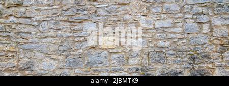 storico vecchio muro di pietra in dettaglio Foto Stock
