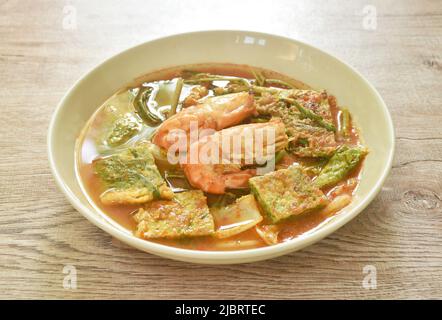 gamberetti bolliti e uova fritte ripiene rampicanti verdure acquose in zuppa acida piccante sul piatto Foto Stock