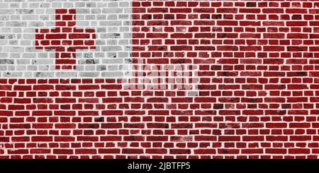 Primo piano su un muro di mattoni con la bandiera di Tonga dipinta su di esso. Foto Stock