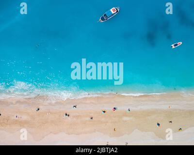 Direttamente sopra la vista della spiaggia di egrenni sull'isola di Lefkada, Grecia copia spazio piccola nave da crociera Foto Stock