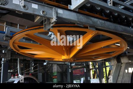 Grande ruota di metallo gialla per la rotazione del cavo dello ski lift Foto Stock