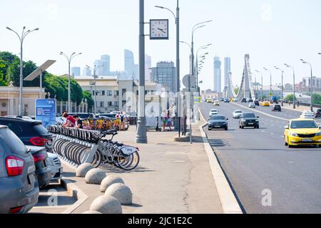 Mosca. Russia. Giugno 9, 2022. Un sacco di biciclette e scooter elettrici a noleggio in uno speciale parcheggio sulla strada di Mosca in una giornata estiva. Trasporto alternativo rispettoso dell'ambiente. Foto Stock