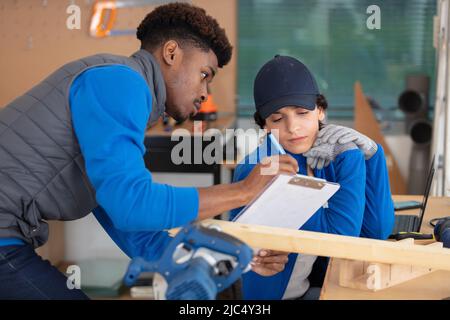 affidabile carpentiere femmina che misura in officina Foto Stock