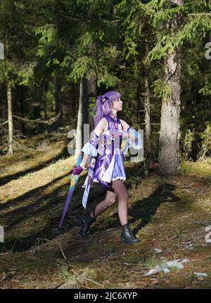 ragazza cosplay keqing genshin impatto sullo sfondo della foresta Foto Stock