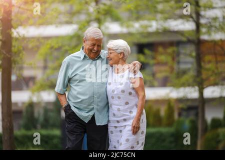 Coppia anziana innamorata camminando nel parco Foto Stock