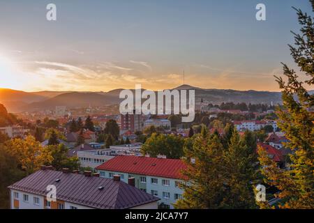 Banska Bystrica, Slovacchia - 13 agosto 2021: Paesaggio urbano estivo al tramonto - edifici colorati, verdi colline all'orizzonte Foto Stock