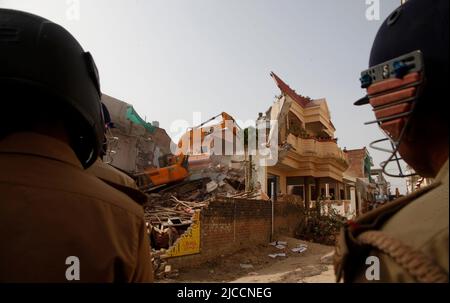 Prayagraj, India. 12th giugno 2022. Bulldozer che è usato da Prayagraj autorità di sviluppo amministrazione per demolire la residenza illegalmente costruita del cospiratore principale di protesta violenta e di pietra pelando la domenica a Prayagraj, India. Le proteste sono scoppiate in diverse parti del paese venerdì (10 giugno 2022) contro il portavoce del partito Bharatiya Janata hanno ora sospeso il commento derogatorio di Nupur Sharma sul Profeta Muhammad. Le proteste nel Prayagraj di Utttar Pradesh e in altri stati si sono trasformate in violente dove la polizia ha dovuto ricorrere alla lathi-carica. Credit: Anil Shakya/Alamy Live News Foto Stock