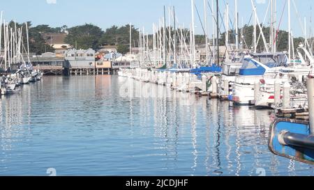 Colorate case di legno su pali, piloni o pilastri, baia o porto, acqua di mare. Vecchio Fisherman's Wharf. Barche a vela, barche a Monterey Marina, California costa USA. Lungomare turistico. Foto Stock