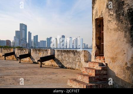 Vista dalle mura della città con bastioni e cannoni e lo skyline della moderna Cartagena sullo sfondo, la Colombia, patrimonio mondiale dell'UNESCO Foto Stock