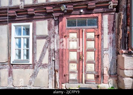 Vecchia scuola, porta d'ingresso, posto vacante, facciata della casa, A graticcio, vista sul villaggio, estate, Wasungen, Turingia, Germania, Europa, Foto Stock