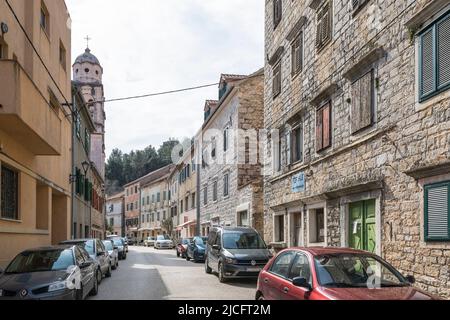 Strada con auto parcheggiate e case tipiche in piccola città Skradin, Sibenik-Knin County, Dalmazia Centrale, Croazia, Europa Foto Stock