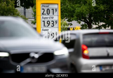 Amburgo, Germania. 14th giugno 2022. I prezzi dei carburanti possono essere visti sul display di una stazione di servizio, auto guidare di fronte ad essa. Credit: Daniel Reinhardt/dpa/Alamy Live News Foto Stock