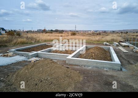 Vista aerea dall'alto in basso dei lavori di costruzione di una nuova fondazione in cemento su cantiere Foto Stock