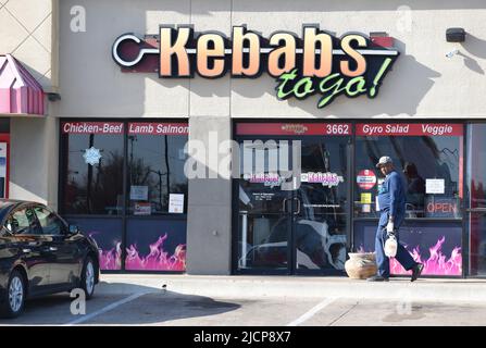 Bug exterinator camminare di fronte a un negozio Kebabs To Go a Irving, Texas Foto Stock