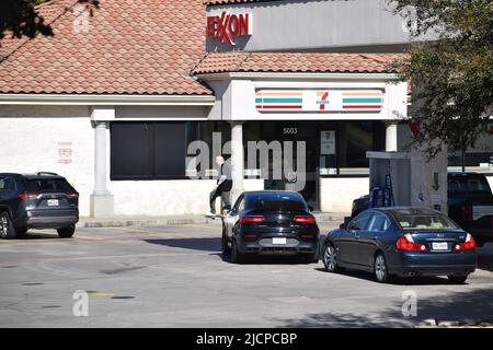 I clienti che si trovano a Irving, Texas, si trovano all'esterno di un vivace minimarket aperto 7-11 ore su 24 Foto Stock