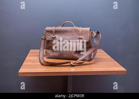 Zaini in pelle marrone su tavola in legno. Borsa UNISEX Foto Stock