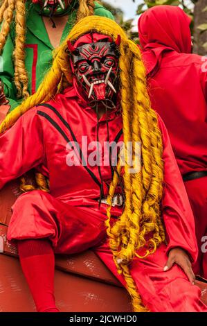 Dancers wearing a traditional devil mask and costumes dance, in which ...