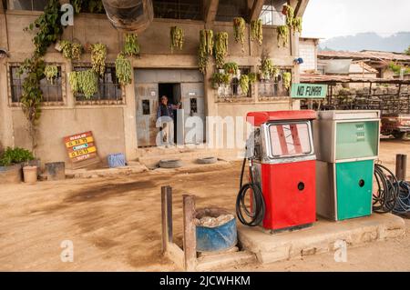 Uomo maya che si appoggia alla porta di una stazione di servizio, in un ambiente rurale, in attesa di clienti , Nahualá, Sololá, Guatemala. © Kraig Lieb Foto Stock