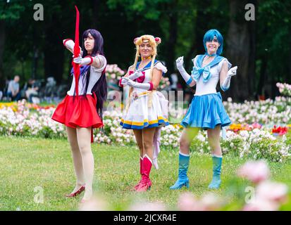 Erlangen, Germania. 16th giugno 2022. I cosplayers Juchan Cosplay (l-r), Luminia e Abysinier si levano in piedi nei loro abiti cosplay come Sailor Mars (l-r), Sailor Moon e Sailor Mercury durante una visita al Salone Comic 2022 a Erlangen nel giardino botanico cortile. Credit: Nicolas Armer/dpa/Alamy Live News Foto Stock