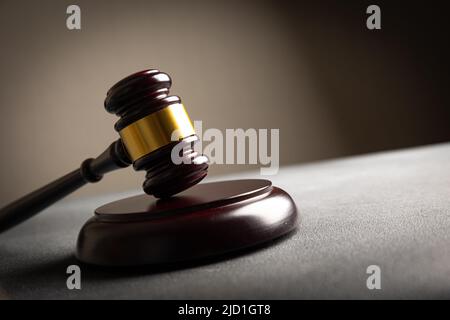 Tema della legge, mazzuolo del giudice sul tavolo di legno con la Statua della Giustizia della Signora. Gavel legge su sfondo scuro e foggioso con luce. Foto Stock
