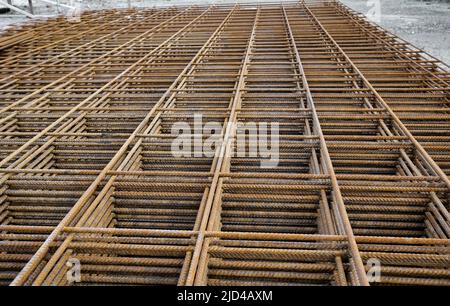 Rete metallica in acciaio arrugginita impilata per lavori su solette di cemento in cantiere Foto Stock