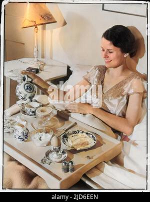 La donna sorridente si versa una tazza rinfrescante di tè prima di infilare in una festa di pompelmo, uovo sodo da una tazza d'uovo & toast servito su un vassoio versione colorizzata di : 10143274 Data: 1930s Foto Stock
