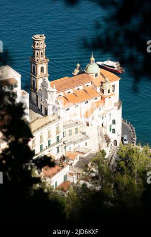 Vista dall'alto, splendida vista aerea di una bella vecchia chiesa con un sottile campanile situato su una scogliera proprio accanto alla costa. Foto Stock