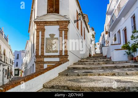 Tipica strada cittadina bianca andalusa con scale e vecchie case. Frigiliana Malaga. Foto Stock