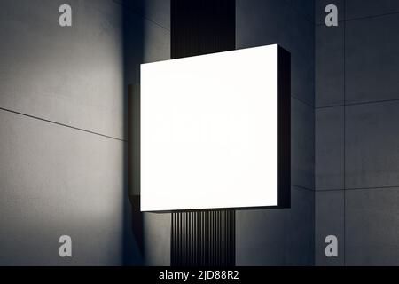 Vista prospettica su una segnaletica quadrata bianca illuminata su un moderno edificio dalle pareti scure con copyspace per il logo o il nome dell'azienda. 3D rendering Foto Stock