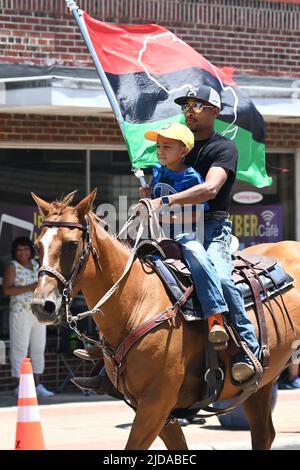 I cowboys afroamericani sfilano a cavallo attraverso Zebulon, NC, come parte di un fine settimana di celebrazione giunettesimo di emancipazione dalla schiavitù. Foto Stock