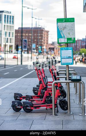 Voi e-scooters a Mann Island - la stazione di Strand bike a Liverpool, Inghilterra, Regno Unito Foto Stock