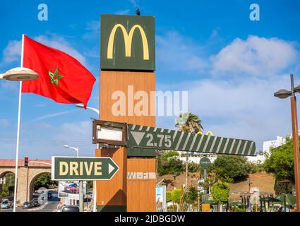Ristorante McDonald's a Rabat, la capitale del Marocco. Bandiera marocchina che svetta accanto al logo McDo e al cartello drive-through Foto Stock