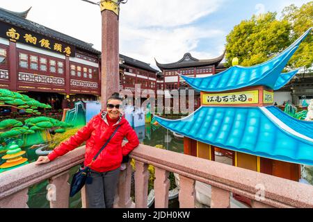 Un turista zig-zag il loro senso attraverso il famoso ponte nove-giring a Yu Yuan durante la festa della lanterna. Foto Stock