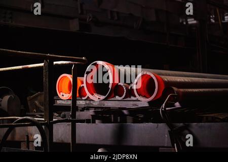 Tubo di ferro caldo rosso colato di fresco alla fonderia Foto Stock