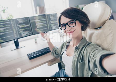 Auto-ritratto di attraente ragazza esperta allegra dimostrando codice html database di rete al posto di lavoro spazio al chiuso Foto Stock