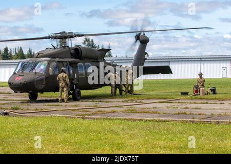 Soldati assegnati alla Alpha Company, 46th Aviation Support Battaglione, 16th Combat Aviation Brigade, operano un punto di armamento e rifornimento in avanti presso l'aeroporto di Chehalis-Centralia, Washington il 22 giugno 2022. I soldati stavano addestrando la Riserva dell'esercito degli Stati Uniti e i servicembers dell'aeronautica degli Stati Uniti sulle procedure di rifornimento dell'elicottero. (STATI UNITI Foto dell'esercito di Capt. Kyle Abraham, 16th Brigata dell'aviazione di combattimento) Foto Stock