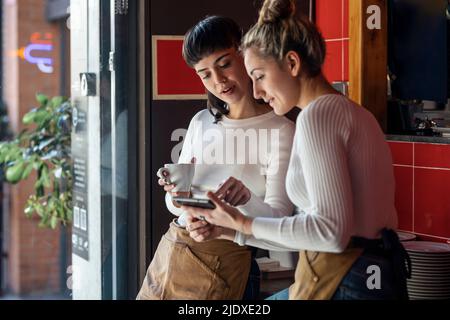 I proprietari di ristoranti discutono di più di un tablet PC Foto Stock