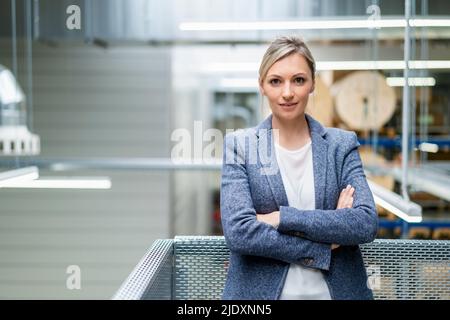 Ritratto di fiducioso imprenditrice in fabbrica Foto Stock