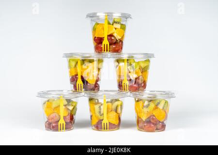 Contenitori di frutta sbucciati e tagliati pronti a mangiare in una dieta sana. Foto Stock