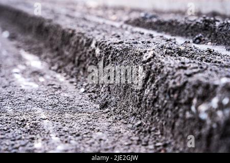 Una vista ravvicinata di una sezione della vecchia riparazione del fondo stradale Foto Stock