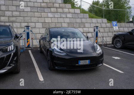 Bergsbygda, Norvegia - 25 maggio 2022: Uno scatto statico di una carica a doppio motore Tesla modello 3 nero solido presso la stazione di ricarica CA Foto Stock