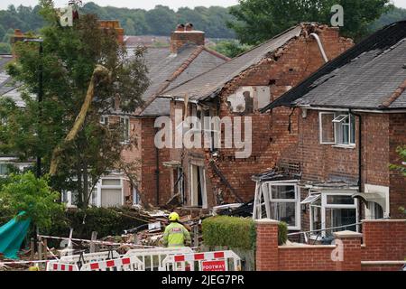 Servizi di emergenza sul posto in Dulwich Road, Kingstanding, dove un'esplosione la domenica ha distrutto una casa e ha causato danni ad altre proprietà e veicoli nelle vicinanze. Data foto: Lunedì 27 giugno 2022. Foto Stock