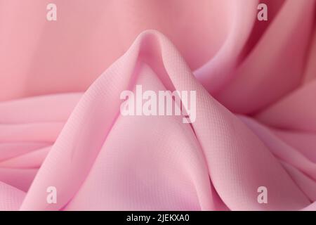 Tessuto sintetico di cotone in morbido primo piano di colore rosa Foto Stock