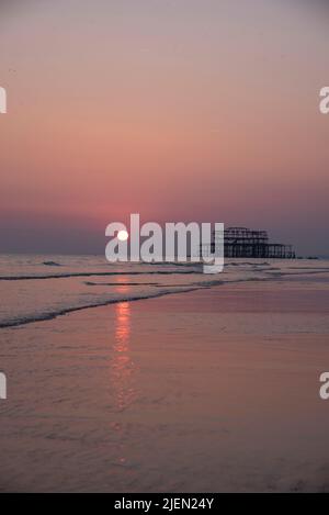 Molo ovest al tramonto su una bassa marea. Brighton. Foto Stock