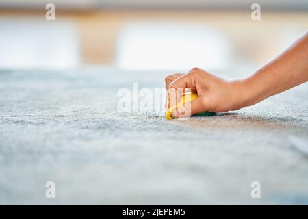 Immagine della mano con la spugna per la pulizia del tappeto Foto Stock